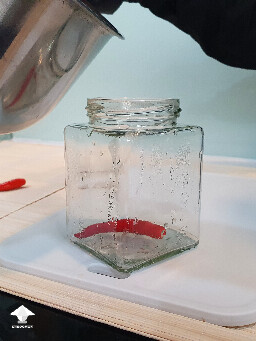 Filling jars with cooked mushrooms for further fermentation