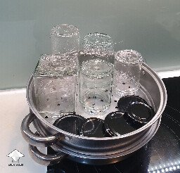 Sterilizing jars with steam in a steamer for canning fermented mushrooms