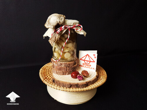 Homemade fermented mushrooms in decorated jar