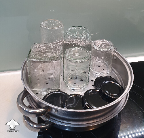 Sterilizing jars with steam in a steamer for canning fermented mushrooms