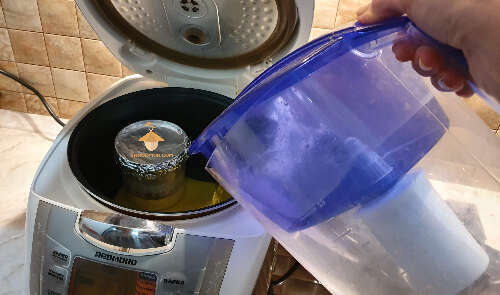 Fill the multicooker (or pressure cooker) with water for sterilization substrate